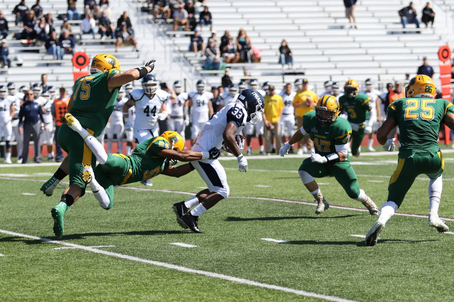 Defense making the tackle against Ithaca