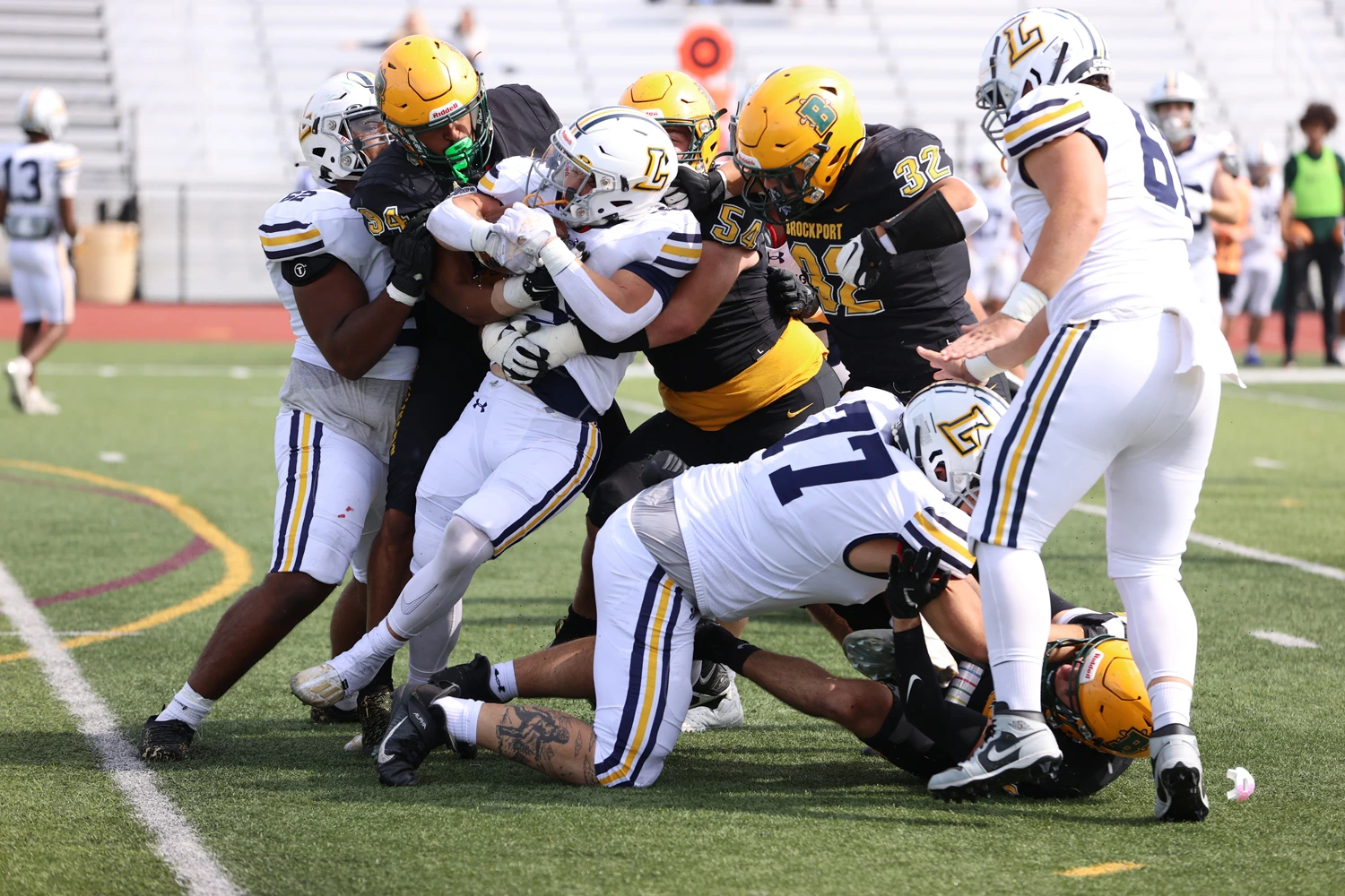 Gang tackle for Brockport against Lycoming